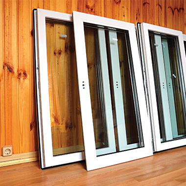 Glass panels leaning against wood paneling